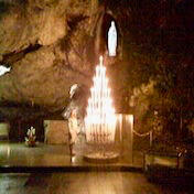 Julie at Lourdes Julie, the founder, standing as a younger pilgrim in Lourdes, France.
