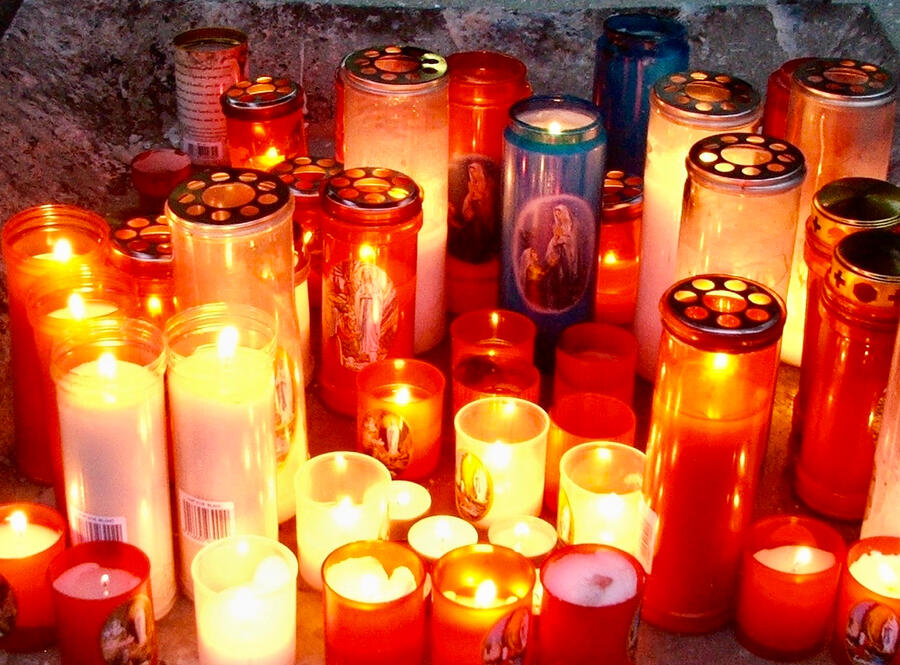 Lit Candles at Lourdes Many beautiful clusters of lit candles glowing warmly at the shrine of Lourdes.
